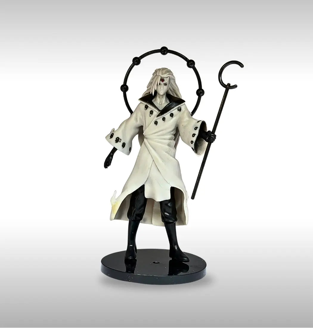 madara uchiha  igurine of a character in a white robe with gray background