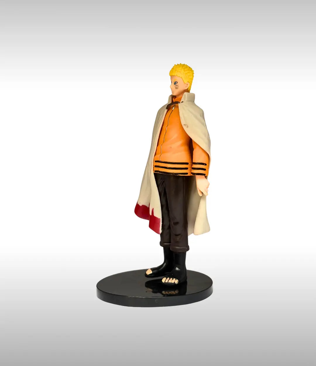 Figurine of a character in an orange jacket with a cape on a gray background