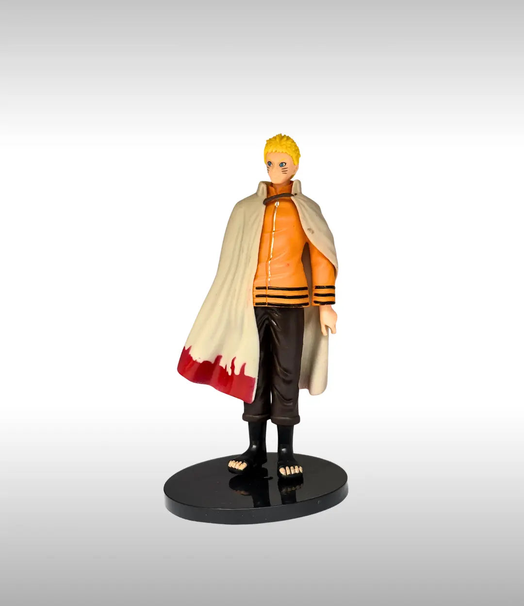 Uzumaki Action figure with orange outfit and cape on a gray background