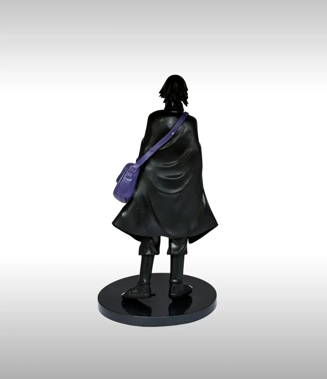 Black figurine with a purple bag on a gray background