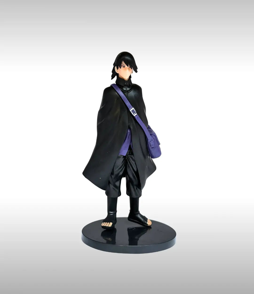 Figurine of a character in a black outfit with a purple bag on a gray background