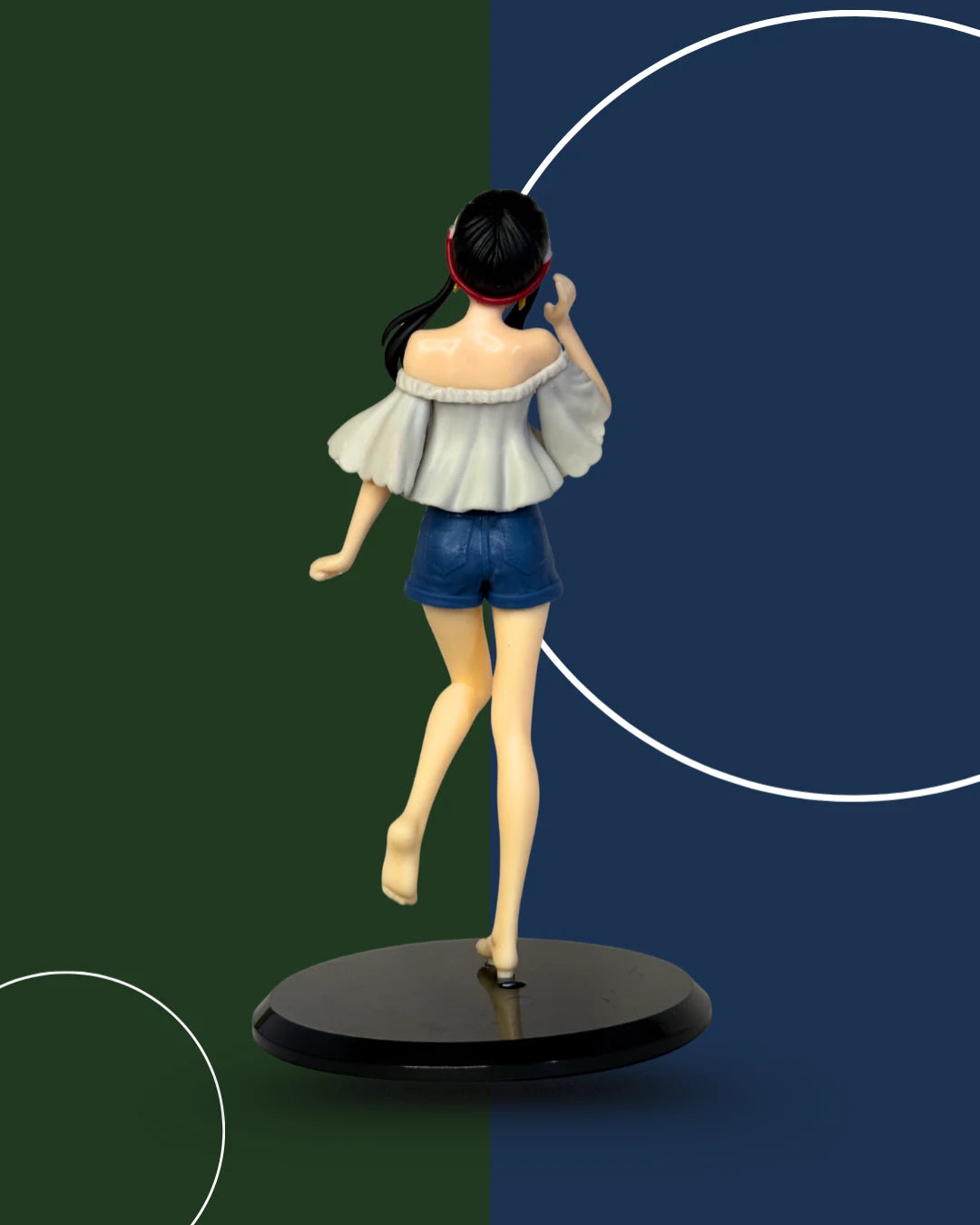 Figurine of a person in a white top and blue shorts on a black base against a green and blue gradient background.