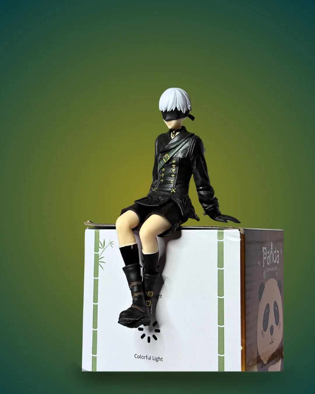 Figurine of a character from a anime or manga sitting on a box with a gradient green background