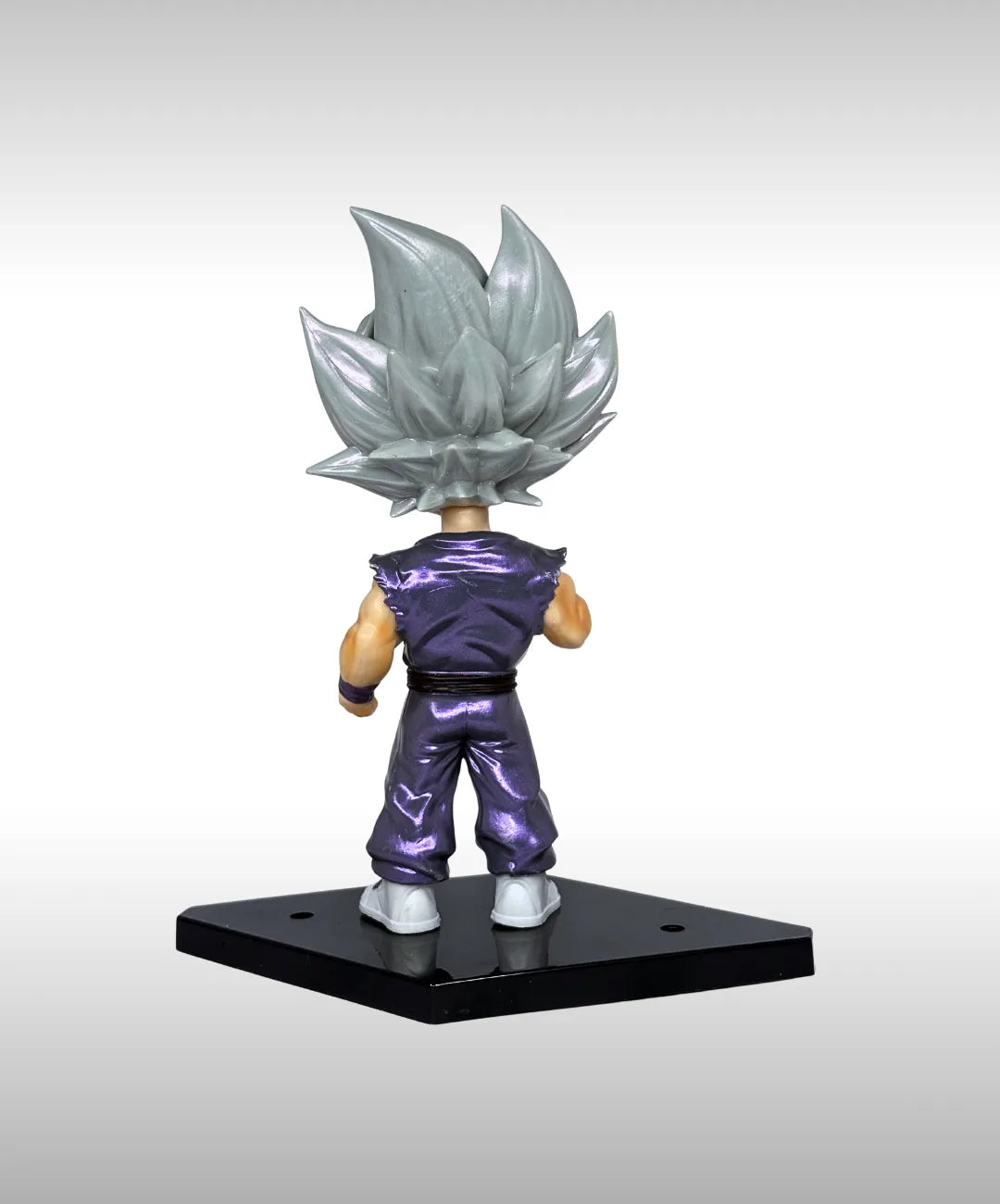 Figurine of a character with silver hair and purple outfit on a black base against a gray background