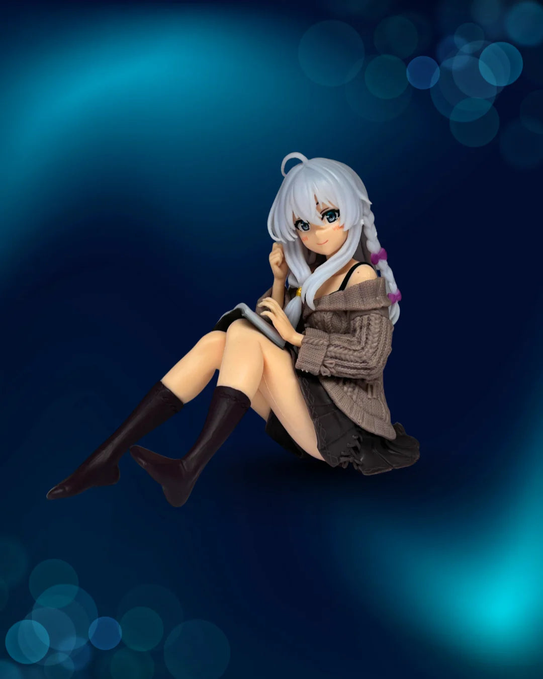 Anime character figurine sitting on a blue gradient background