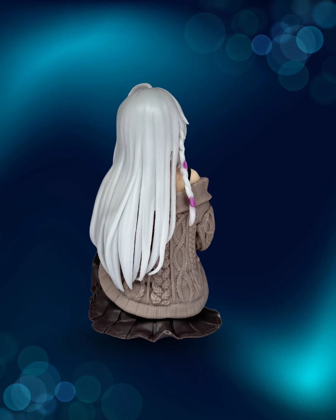 Statue of a person with long white hair and a brown coat against a blue bokeh background