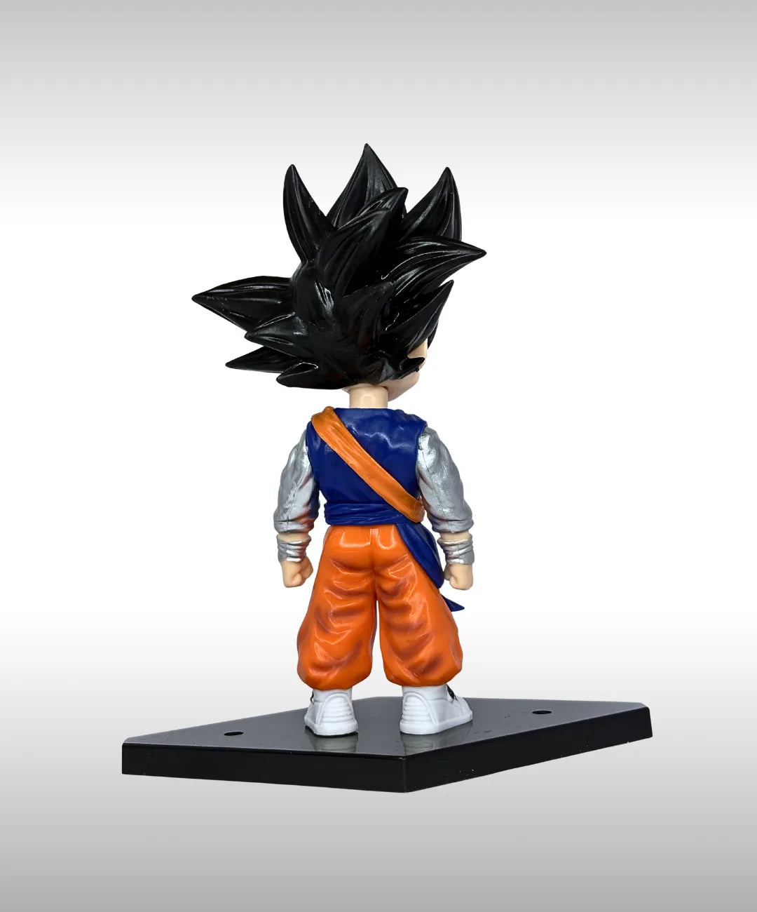 Action figure of a character in a blue and orange outfit with a black helmet on a gray background