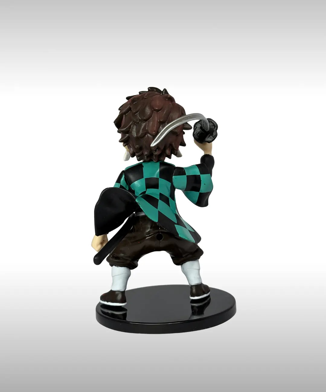 Figurine of a character with a checkered jacket and a weapon on a white background