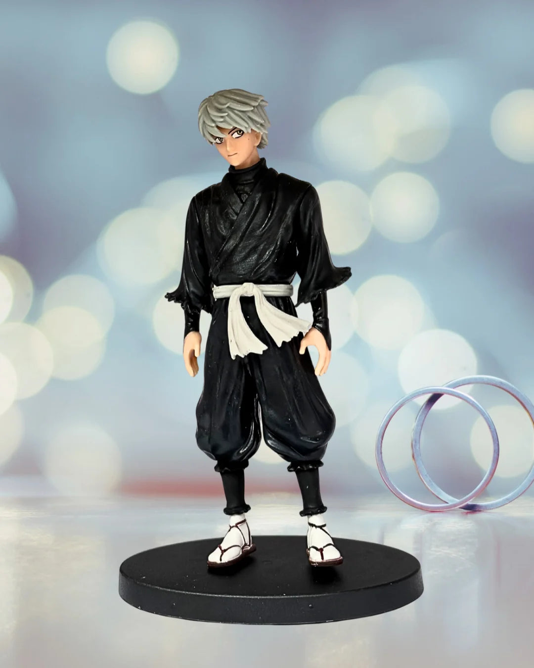 Action figure in black outfit with white accents on a blurred background