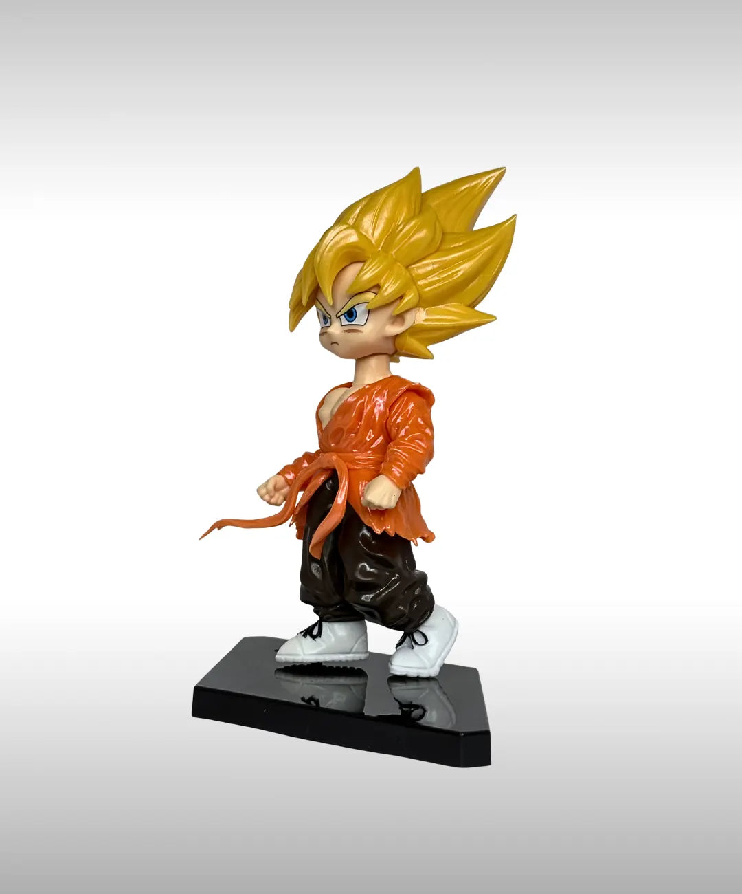 Figurine of a character with spiky hair and orange outfit on a gray background