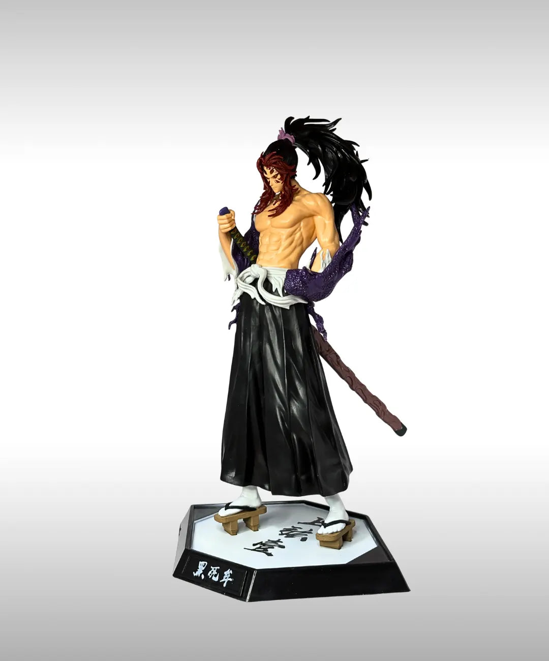 Action figure of a character with long hair and traditional attire on a white background
